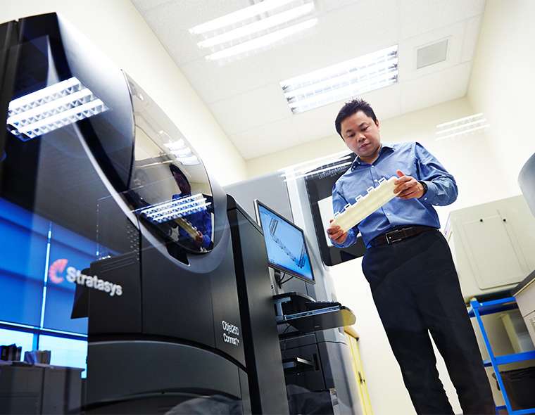 Research and development worker holding a 3D printed device