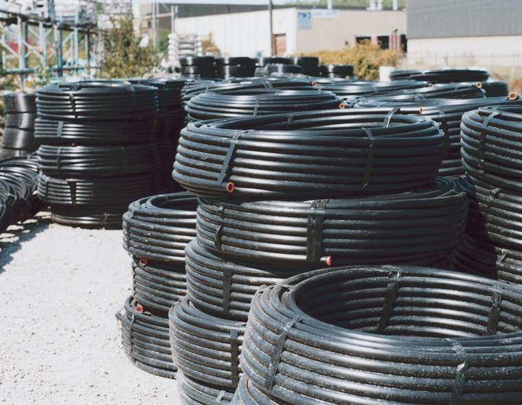 pipe-w-the-stripe-coils-stacked-in-yard