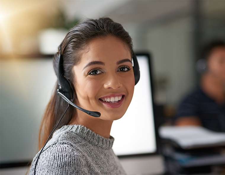 Sales representative wearing a headset while smiling