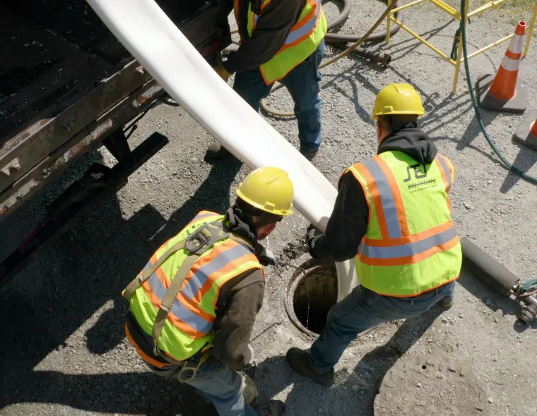 Workers installing NovaForm in sewer